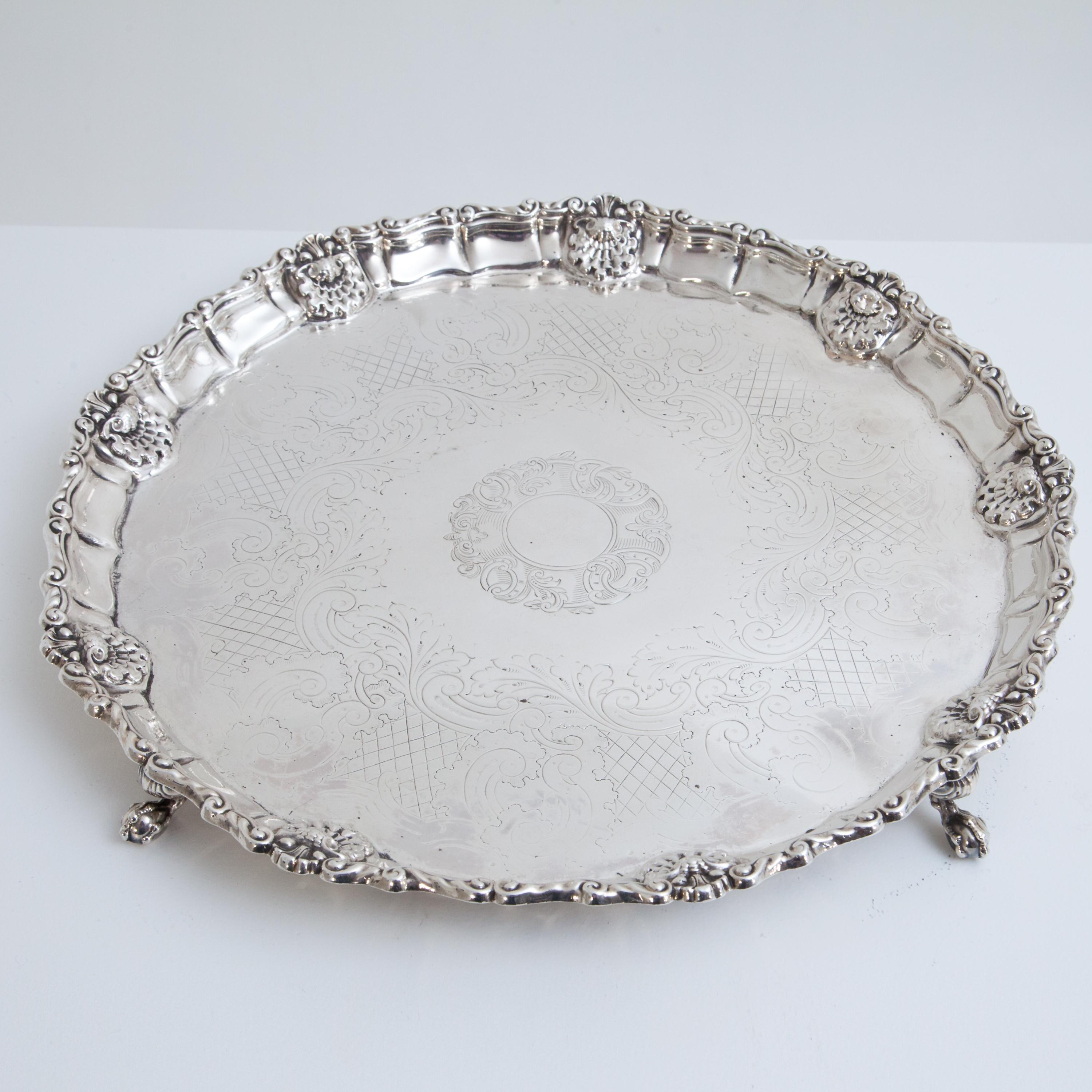 Large silver salver (1460g) with shell decoration on the rim and worn master mark, possibly Benjamin Smith.
 
