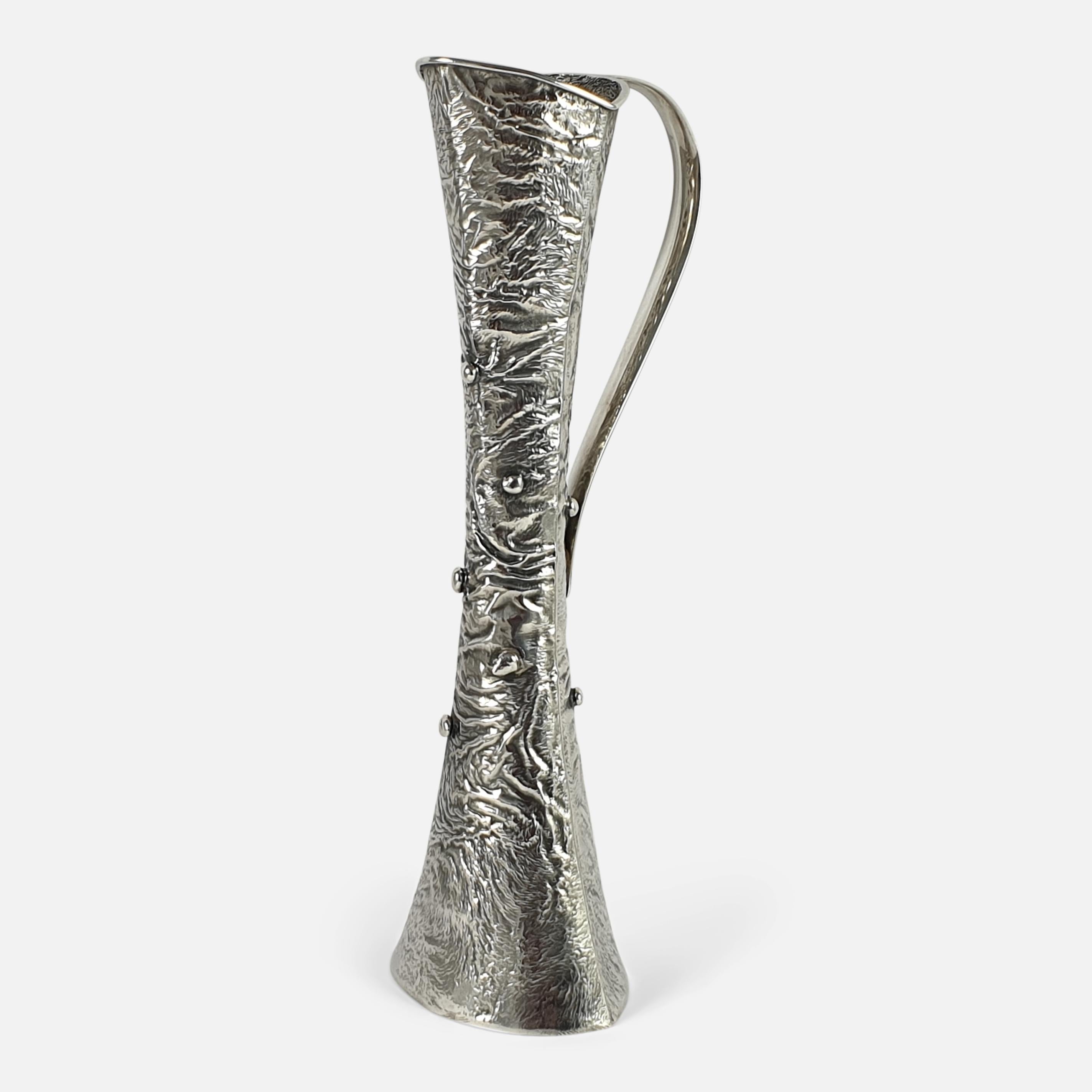 A silver bud vase made by Kultakeskus Oy, Hämeenlinna, Finland, 1972. The bud vase is crafted using the Samorodok technique, and it is of trumpet form, with a single handle. The vase is stamped with the Kultakeskus Oy makers mark (crouching lion),