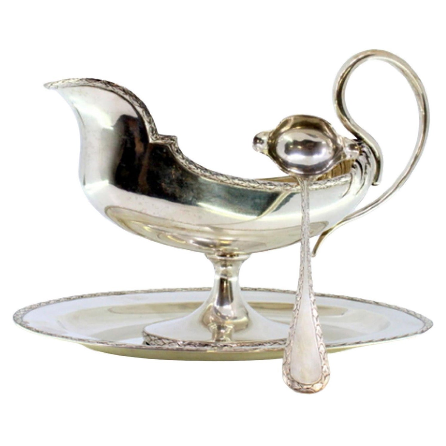 Silver sauce boat in the shape of a ship with a removable plate