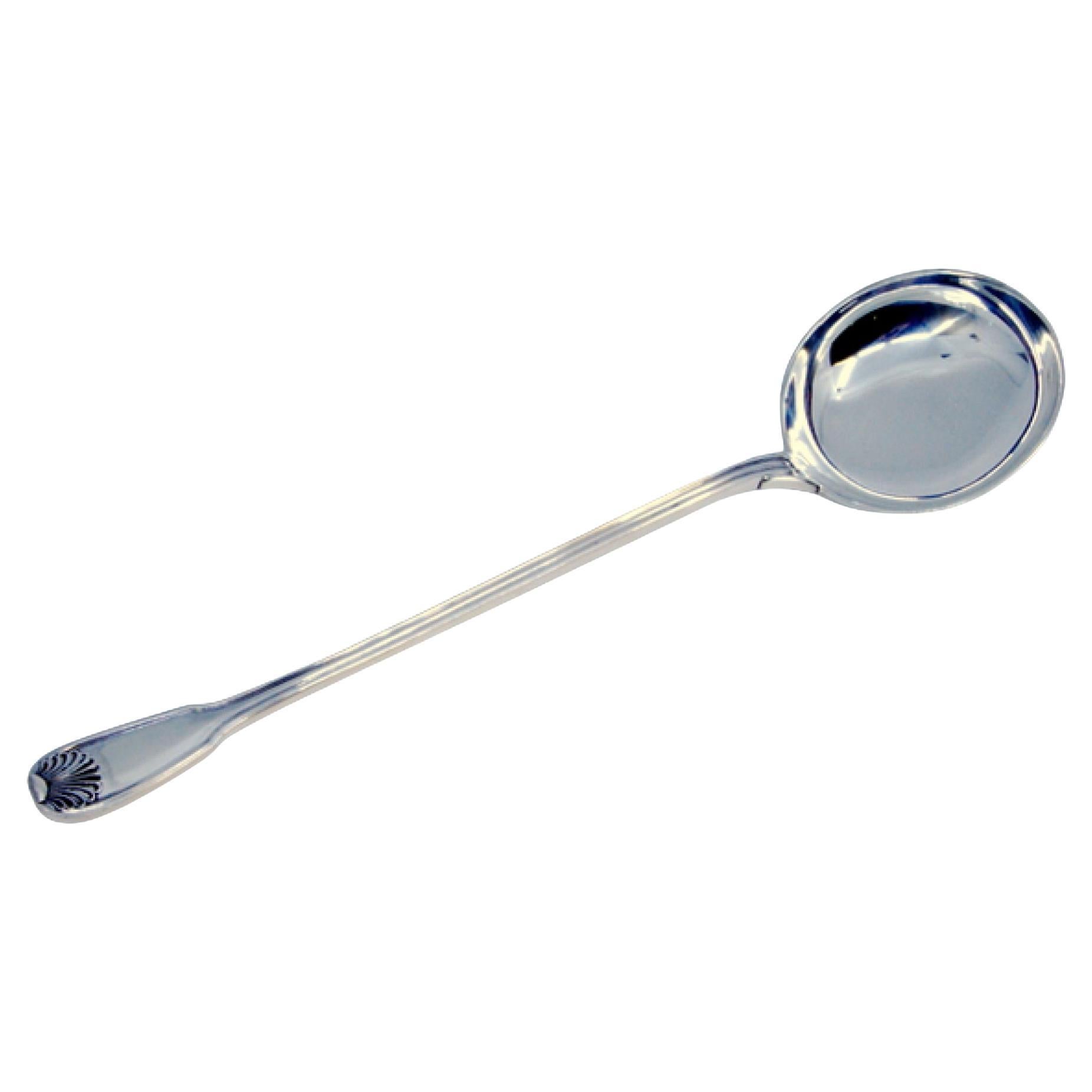 Silver sauce spoon with reliefs and grooves on the handle