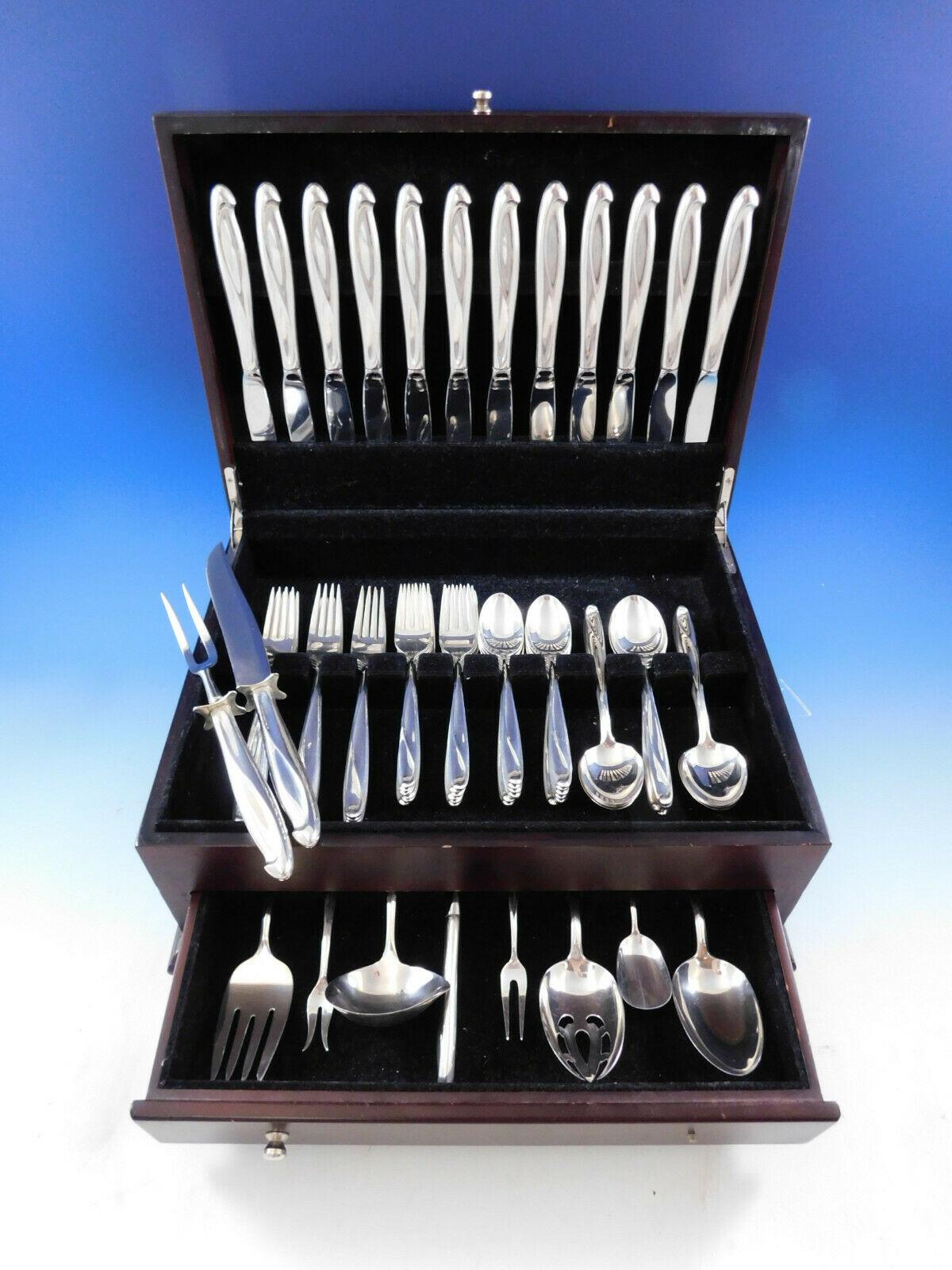 Large silver sculpture by Reed and Barton sterling silver flatware set of 70 pieces. (See photo of Reed & Barton's 1954 advertisement, as illustrated in Modernism in American Silver by Stern book.) This set includes:

12 knives, 9