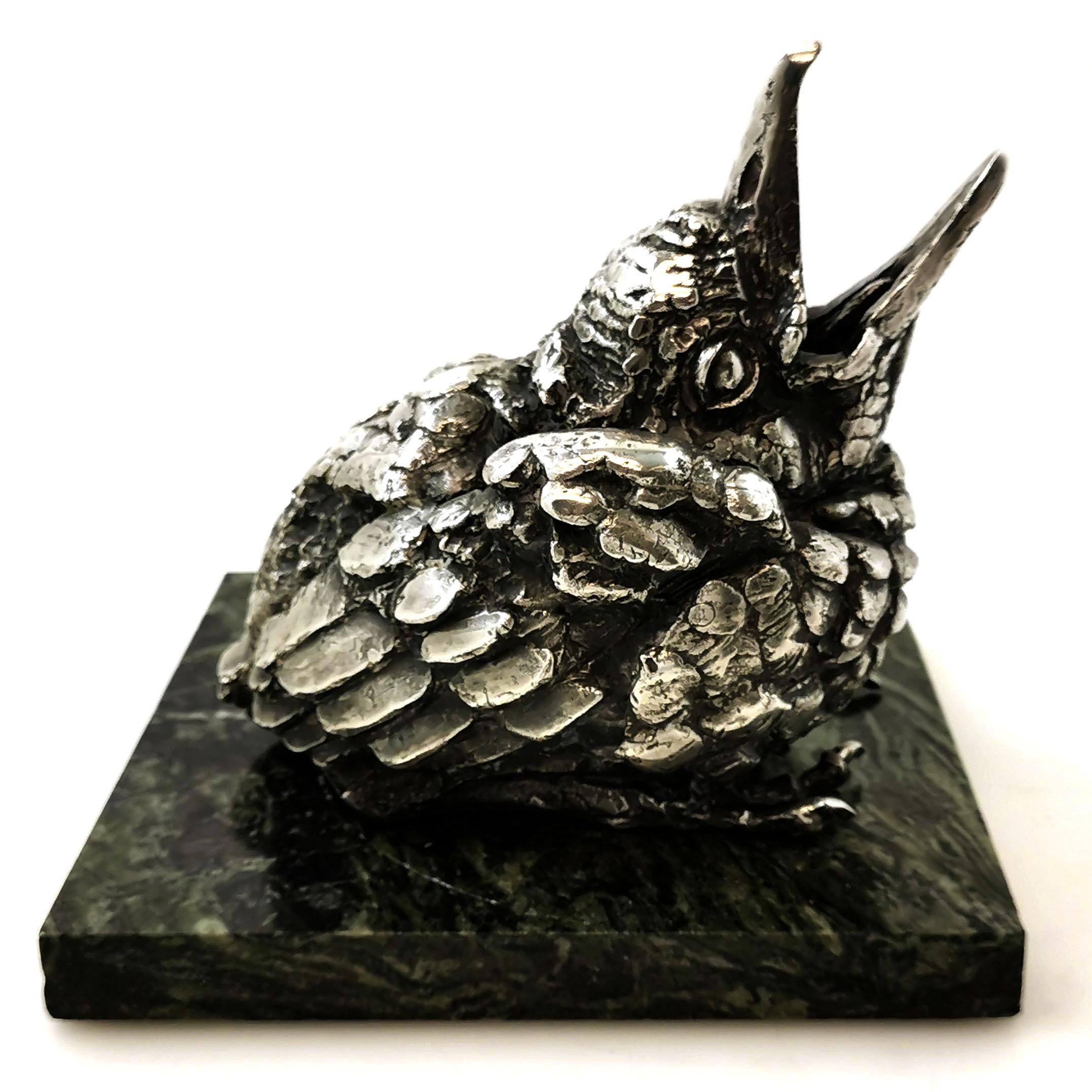 A magnificent sterling Silver Sculpture of a Fledgling Blackbird by sculptor Sally Arnup presented on a green marble base.

Made in Sheffield in 1975 by Sally Arnup FRBS, ARCA (1930-2015).

Approx. Weight (Silver Only) - 5998g / 192.86oz
Approx.