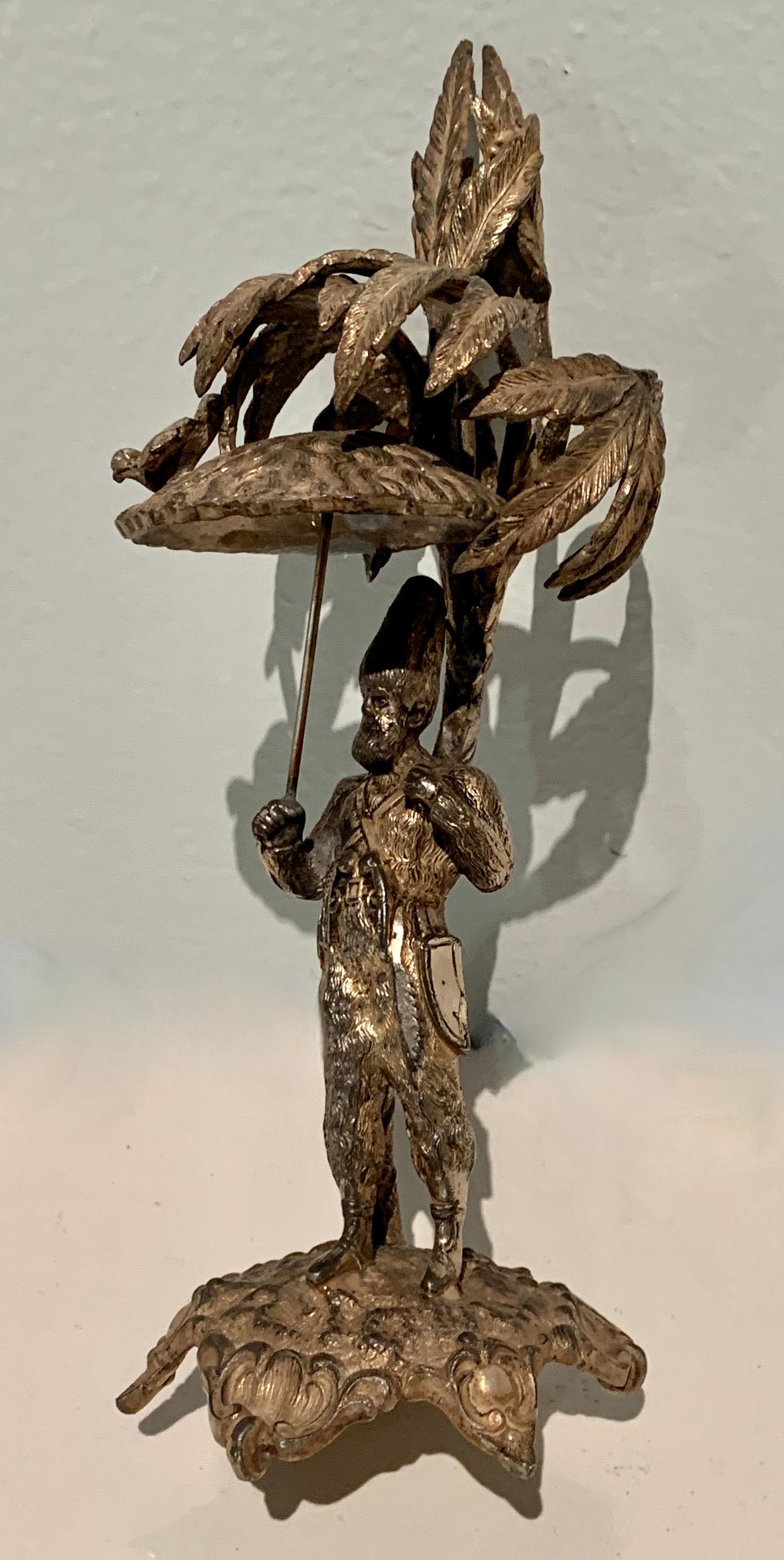 Patinato Scultura in argento raffigurante un uomo che tiene un ombrello con un uccello in vendita