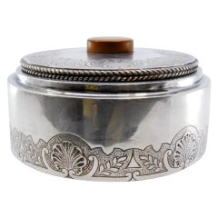 Silver seashell vanity box with a trim on the lid and wooden handle