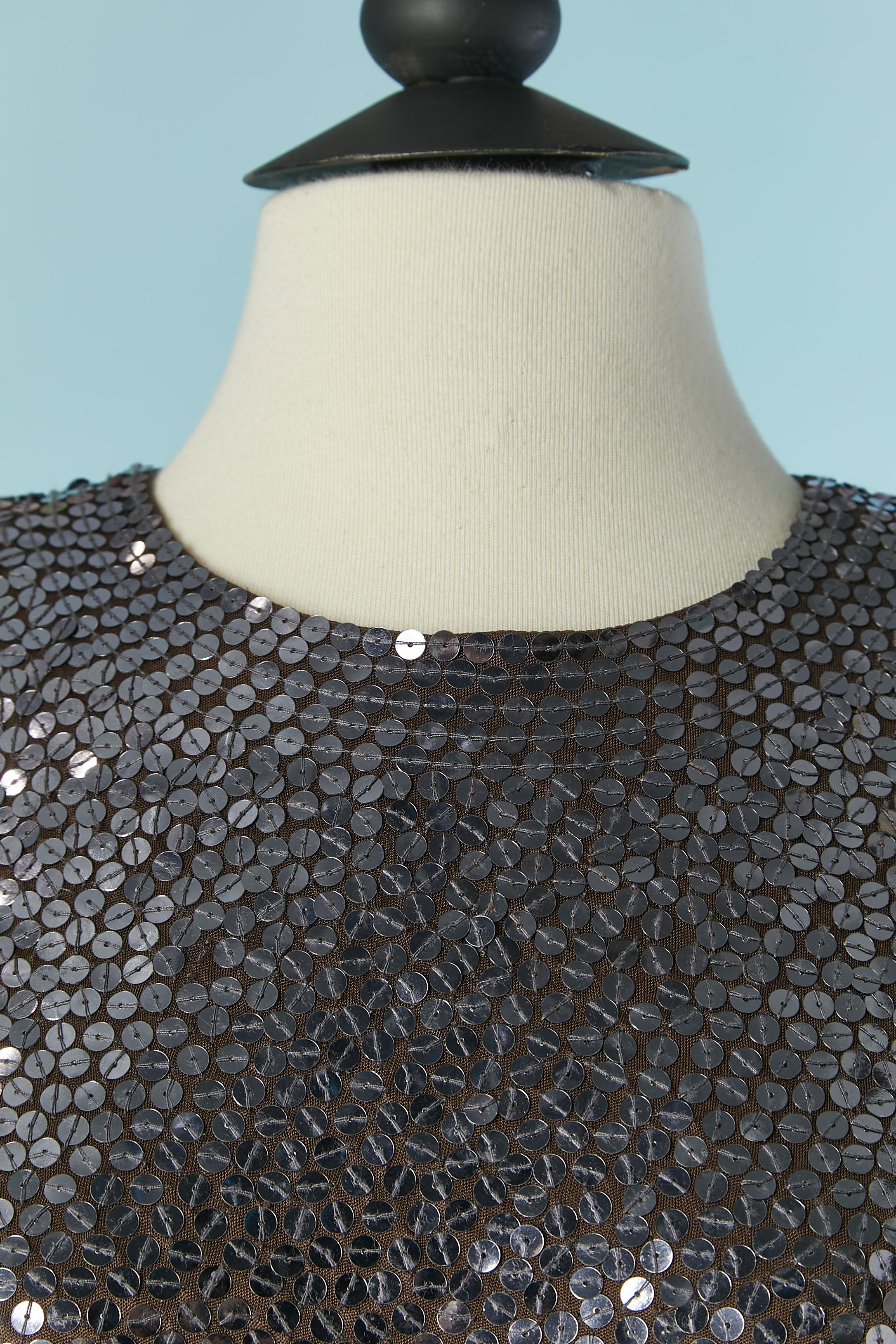 Vestido de cóctel de lentejuelas plateadas sobre base de punto de rayón marrón y forro del mismo tejido. Cierre con cremallera y corchete en la parte central de la espalda. Hombrera.
TALLA M / L 