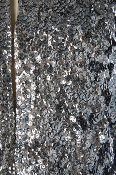 Silver sequin edge to edge evening jacket on a grey knit base Circa 1970's