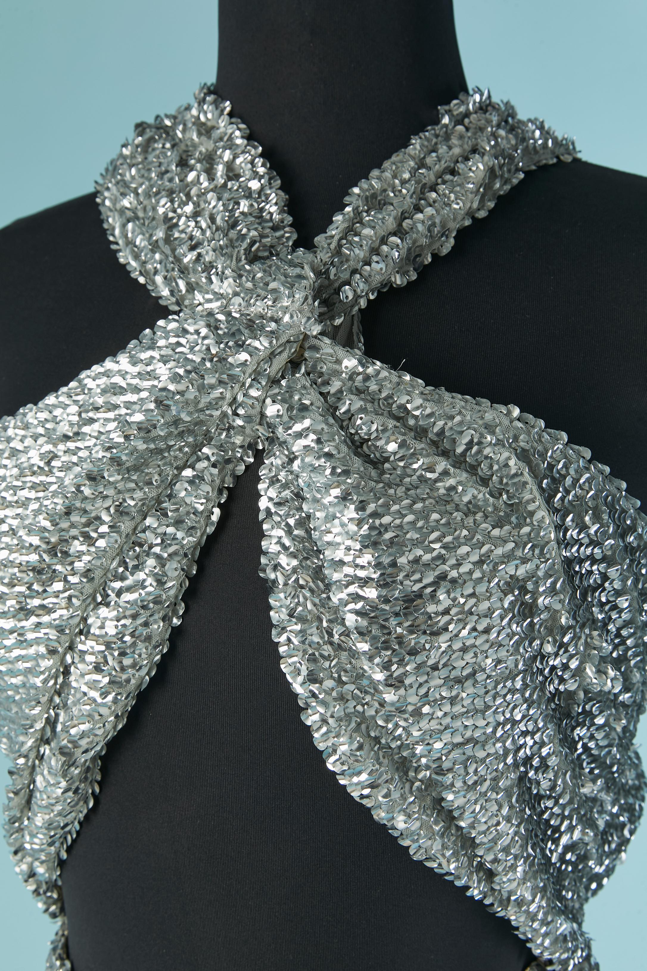 Robe de soirée à paillettes argentées. Doublure en soie. Fermeture à glissière et crochet au milieu du dos. Accroche&œil au dos sur la bandoulière gauche. Fendu sur le milieu du devant, longueur= 95cm
TAILLE 38 (Fr) M 