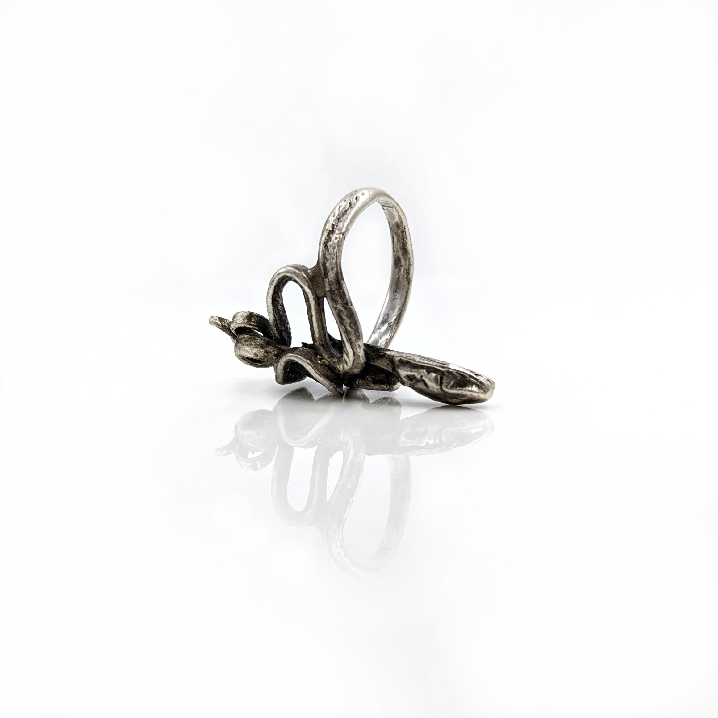 Step into the world of exquisite craftsmanship with the Serpentine Ring in sterling silver. Each piece is meticulously crafted in Asheville, NC. The serpentine design, formed using the lost wax casting method, adds a touch of timeless elegance to