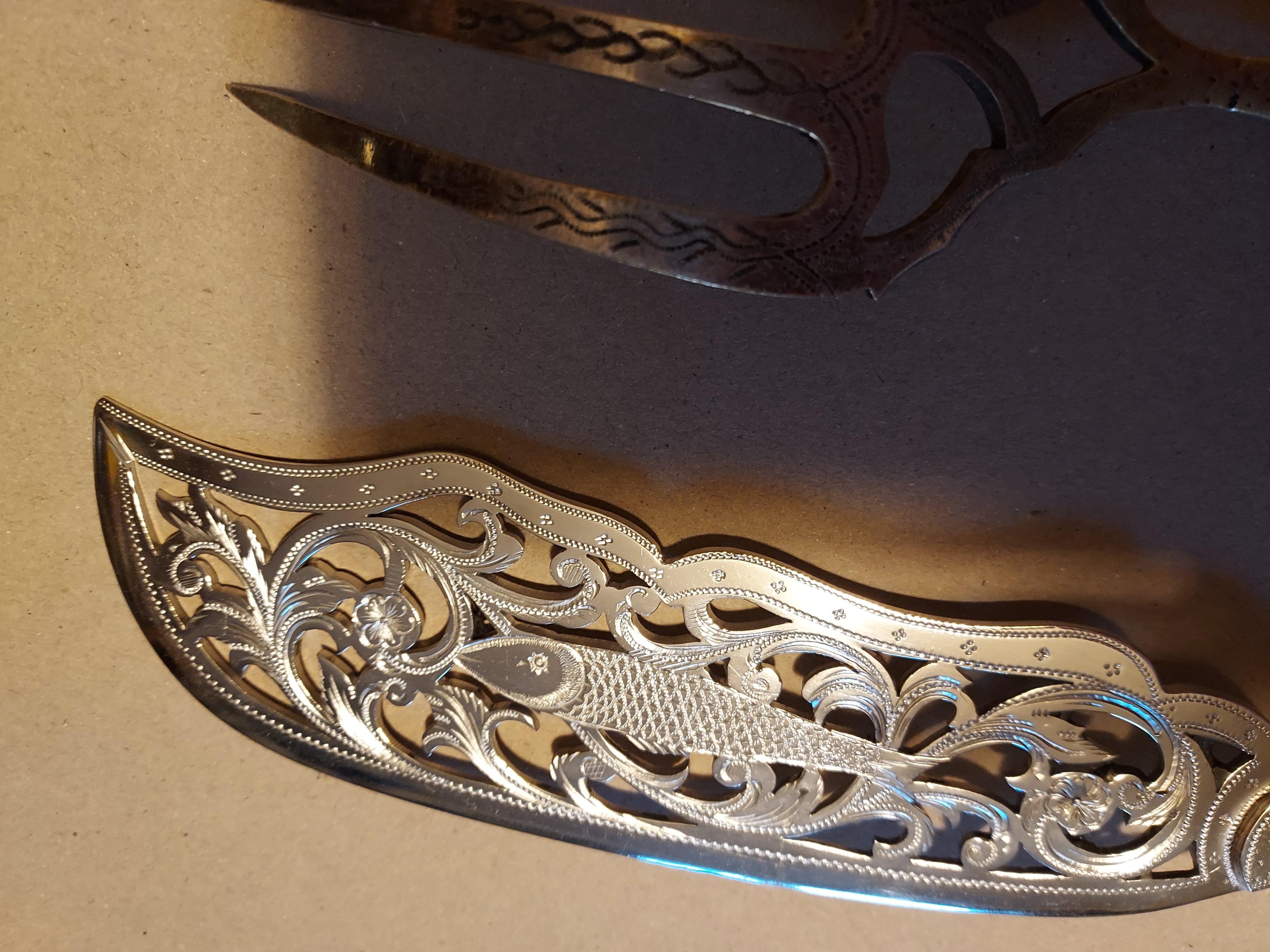 Silver Serving Fish Knife and Fork with rare engine turned handle
 Fish  with beautiful Fish n blade surrounded with filigree foliate scrolls and flowerheads the handle engine turned giving that brilliant polished glistenening surface
A really fine