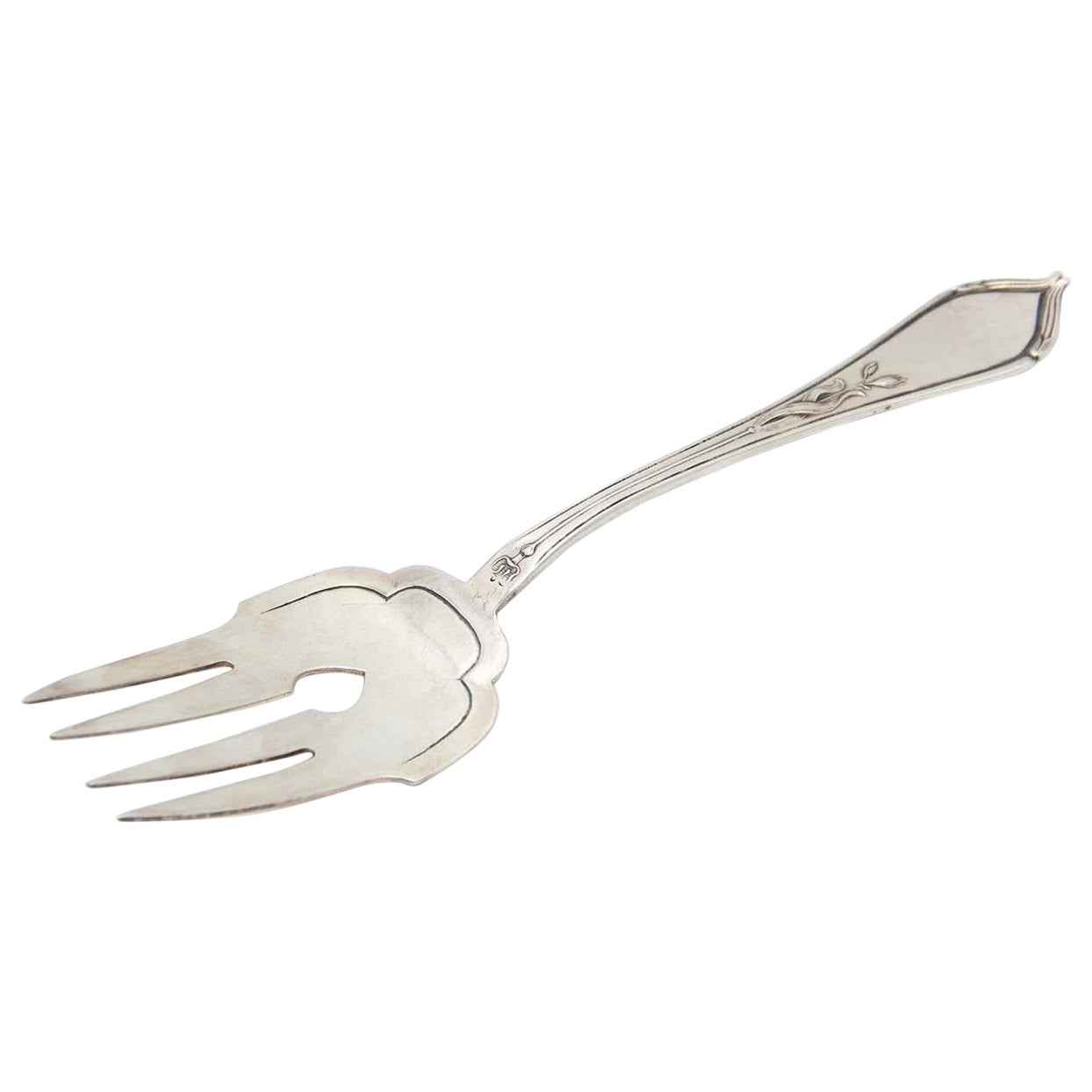 Silver serving fork with four prongs and reliefs