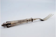 Silver serving fork with three tines and guilloche on the hexagonal handle
