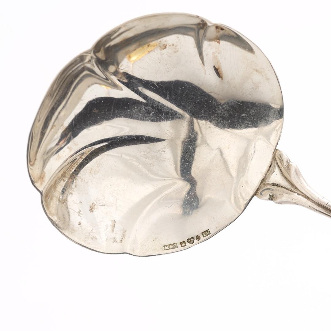 Antique valuable sterling silver serving spoons Decorative tableware pressed, cast and chased, gold gilding on the inside. Oval, domed body on short, curve  All-encompassing C-curves in relief, latticework, rocailles, tendrils of flowers and