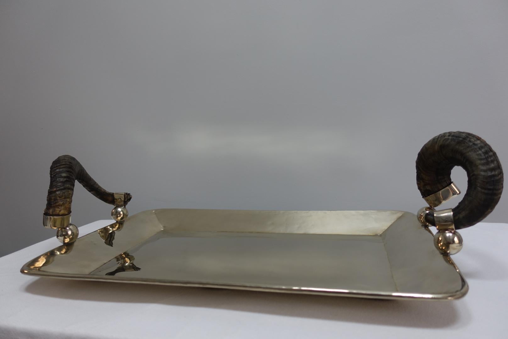 Silver Serving tray with rams horn handles offered for sale is a large elegant silver serving tray hand fitted with rams' horn handles. The silver content is referred to as alpaca silver. A white metal alloy of copper, nickel and zinc. The horns