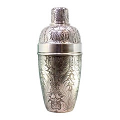 Silver shaker with revealed floral motifs and beading on the lid