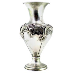 Silver shell-shaped jug with circular base and friezes