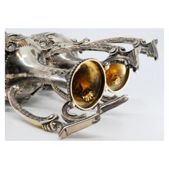 Silver shell-shaped jugs with pearly floral motifs on the base and necks