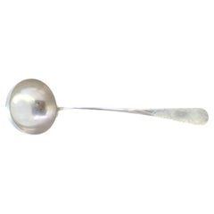Silver shell-shaped ladle with engraved monogram cartouche