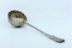 Silver shell-shaped soup ladle with grooved handle & monogram