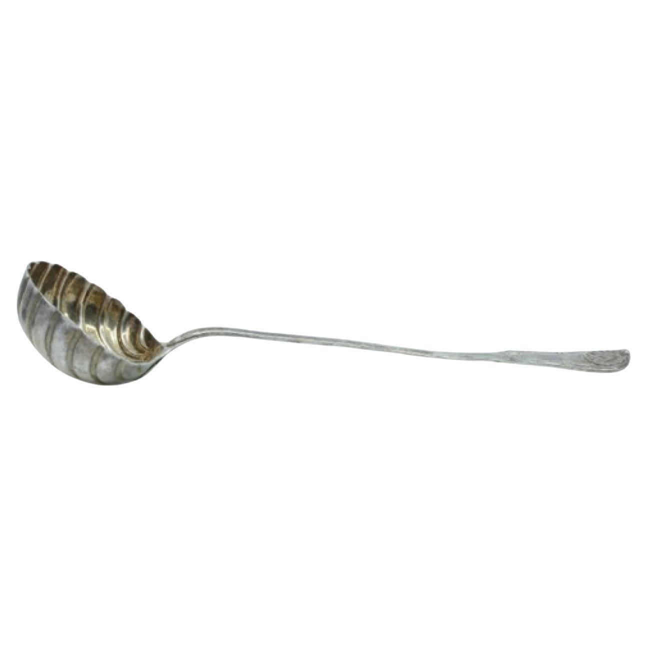 Silver shell-shaped soup ladle with grooved handle 
monogram For Sale