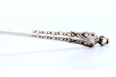 Silver sickle-shaped dessert knife with floral engravings and raised pommel