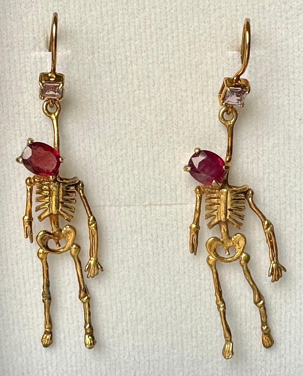 Gold Plated Silver Skeleton Earrings set with Ruby and Tourmaline. These fun earrings are little skeletons with oval Ruby heads, accented with square Tourmalines mounted on the ear hooks. 

Originally from San Diego, California, Kary Adam lived in