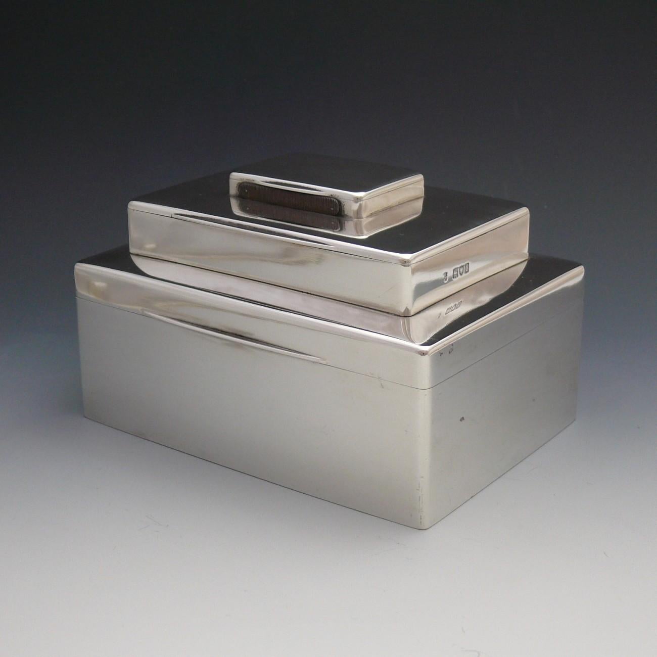 A stylish Sterling silver box made to house cigars, cigarettes and matches, each in their own separate compartment. Made in hallmarked silver; London 1897 and with the cigar compartment lined in cedar.

Dimensions: 14.5 cm/5¾ (width) x 10.5 cm/4⅛