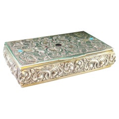 Silver snuff box w/ carved wreaths, hinged lid w/ colored stones
gold interior Silver snuff box w/ carved wreaths, hinged lid w/ colored stones
gold interior