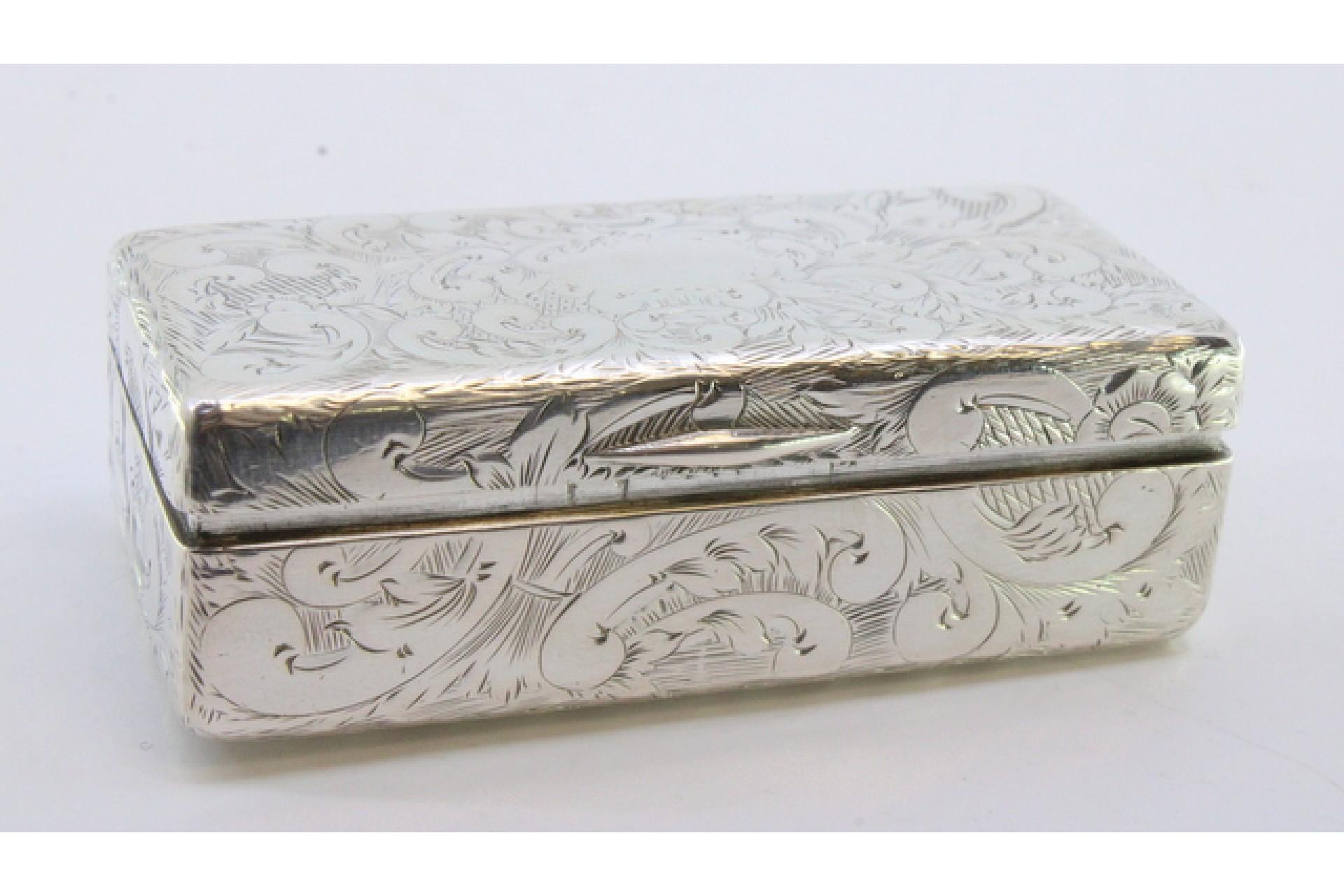Description: Silver snuff box with wreaths and engraved floral motifs surrounding a monogram card. Metal: Silver. Origin: Portuguese. Brand: Porto Coroa. Weight: 75.05 grams. Dimensions: 7cmx3.3cm. Content: 833/1000. Assay Mark: Yes, from the 15th