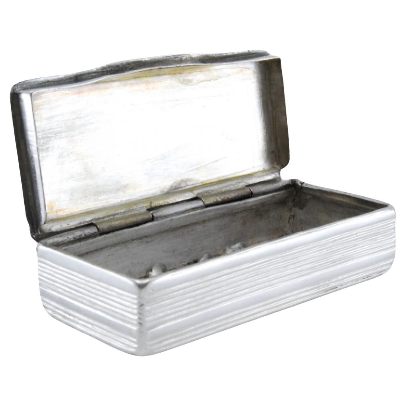 Silver snuff box w/ friezes around the edge, relief country motifs & hinged lid