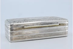 Silver snuff box with border trim and floral-engraved lid