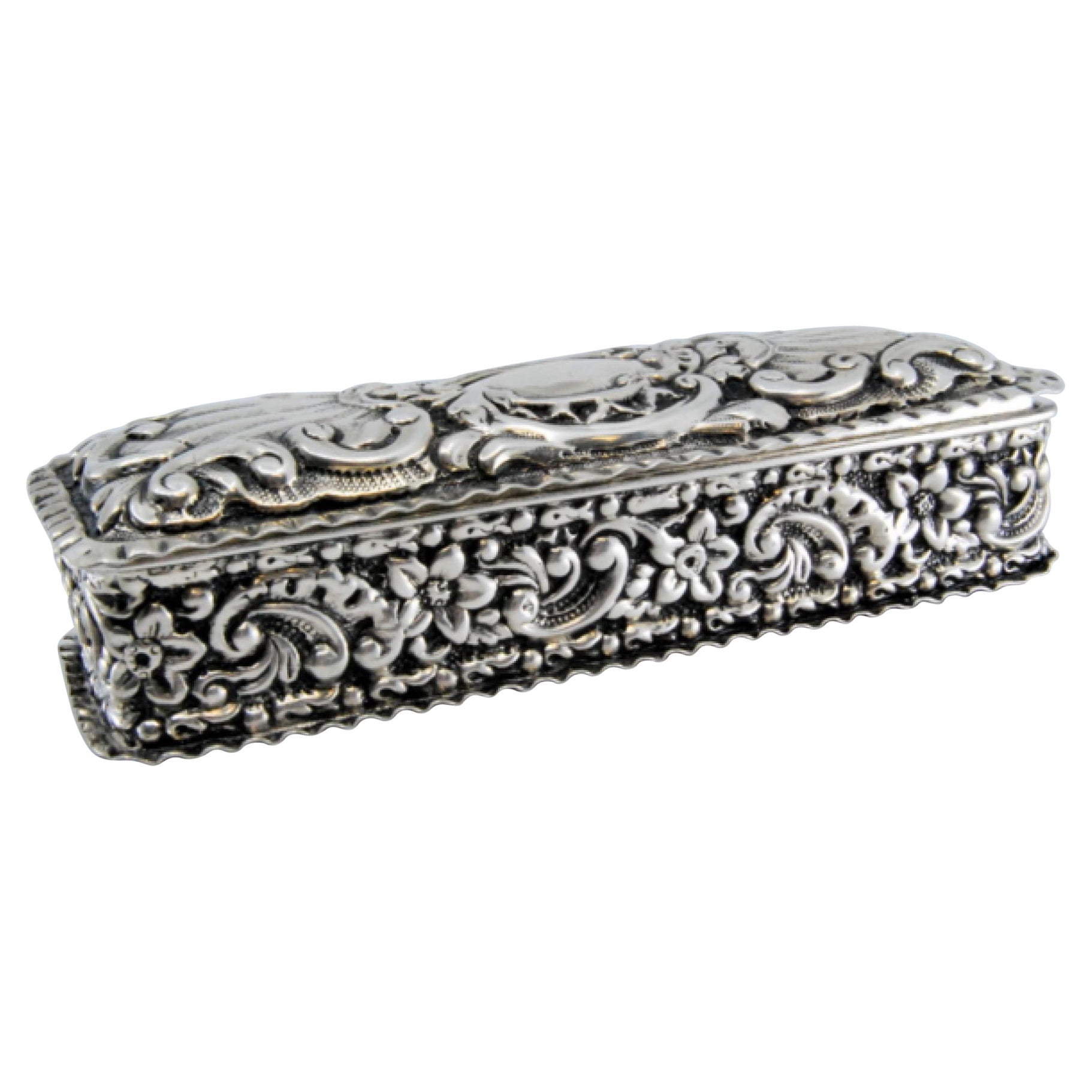 Silver snuff box with embossed designs and hinged lid
