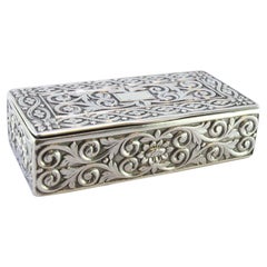 Silver snuff box with embossed floral motifs surrounding a monogram card