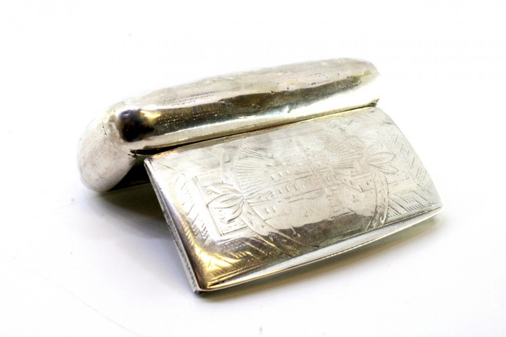 Description: Silver snuff box with engraving and hinged lid. Metal: Silver. Origin: European. Mark: Absent. Weight: 53.32 grams. Dimensions: 8.3cm x 4.5cm. Content: 833/1000. Assay Mark: Absent. Additional information: Good condition - slight dents