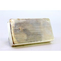 Silver snuff box with engravings surrounding a monogram card on the hinged lid