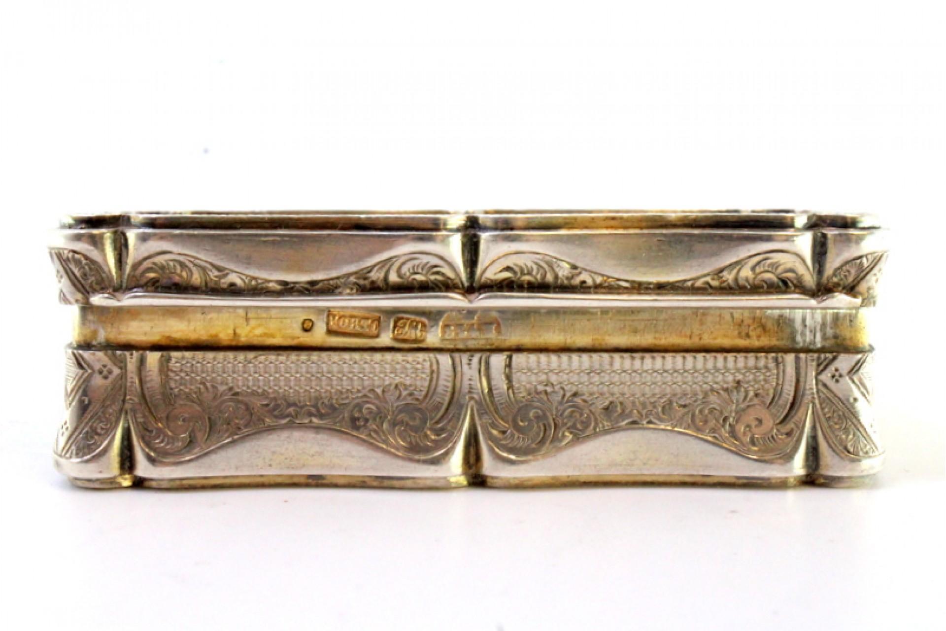 Description: Silver snuff box with engraved garlands surrounding a monogram card and gold interior. Metal: Silver. Origin: Portuguese. Mark: Remarked old man's head. Weight: 119.75 grams. Dimensions: 9cmx4cm. Content: 833/1000. Assay Mark: Yes, from