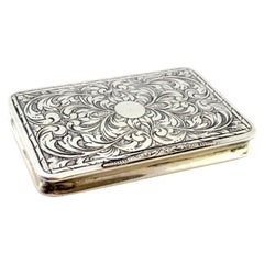 Silver snuff box with raised floral motifs, monogram card and hinged lid