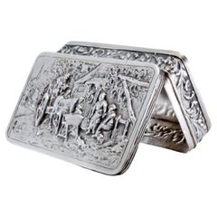 Silver snuff box with relief country motifs on the hinged lid