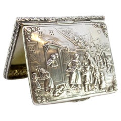 Silver snuffbox embossed with everyday scenes and gold interior