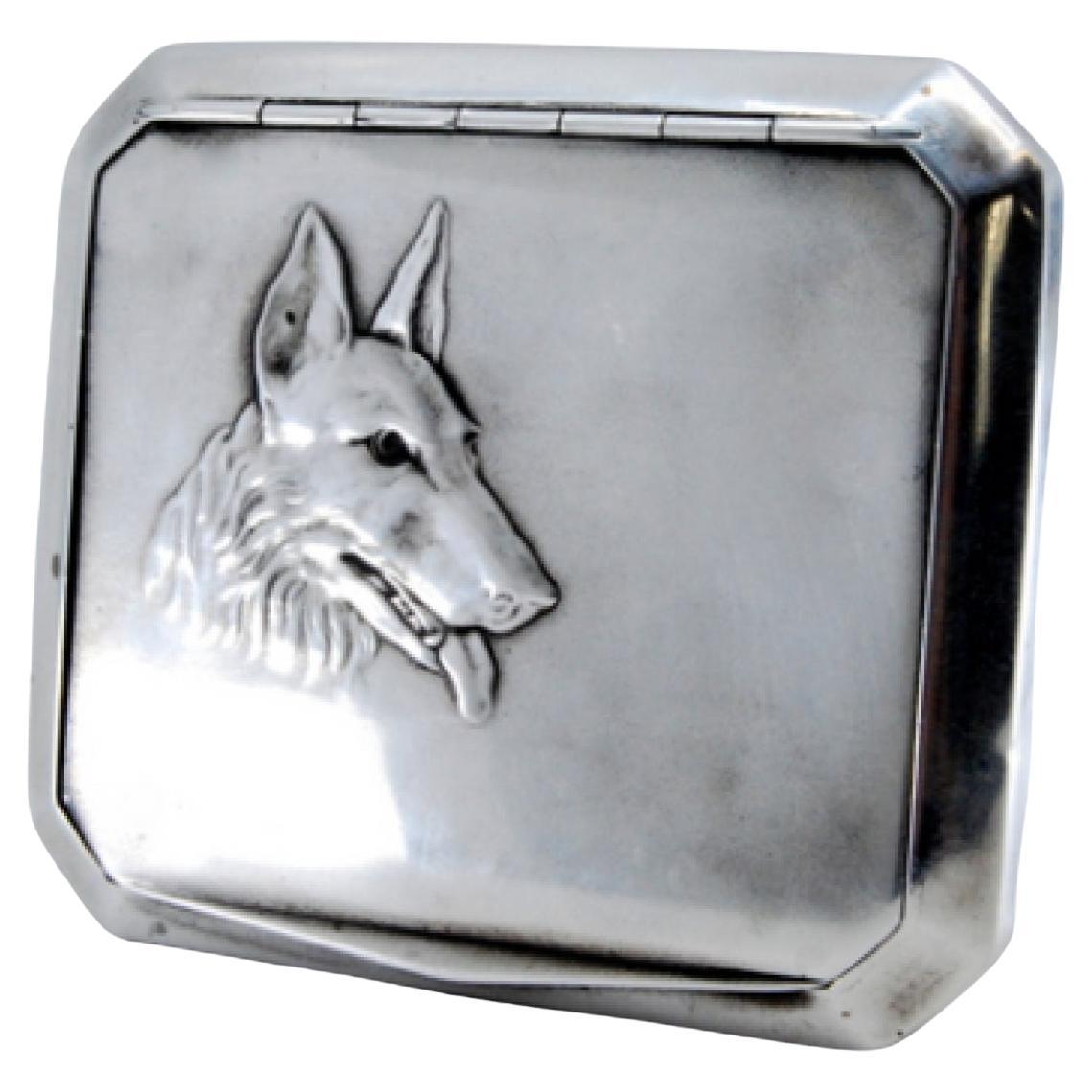 Silver snuffbox with dog relief 
interior paper holder