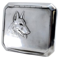 Silver snuffbox with dog relief 
interior paper holder