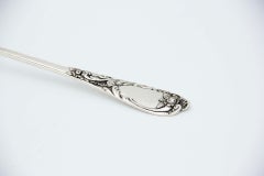 Silver soup ladle embossed on the handle