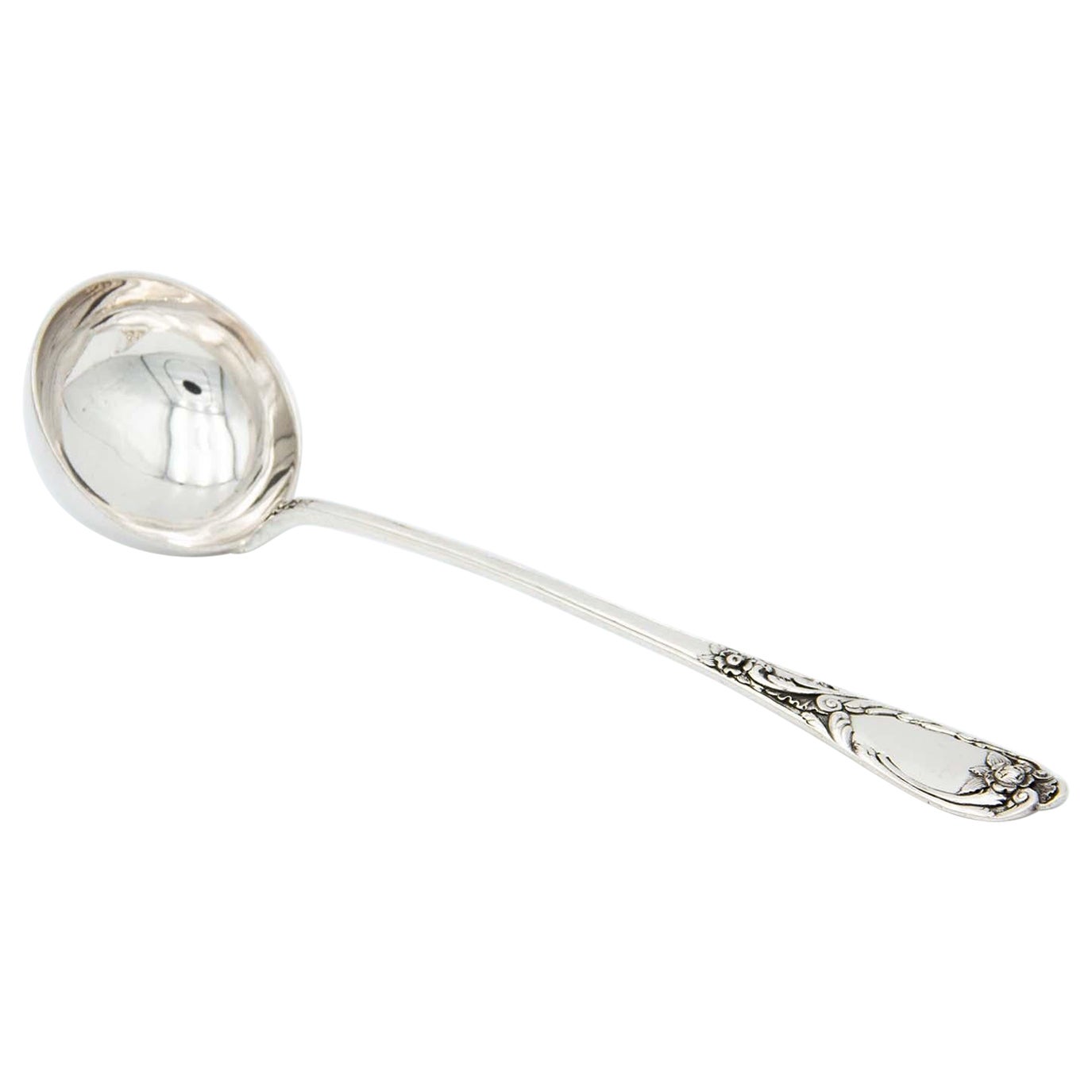 Silver soup ladle embossed on the handle