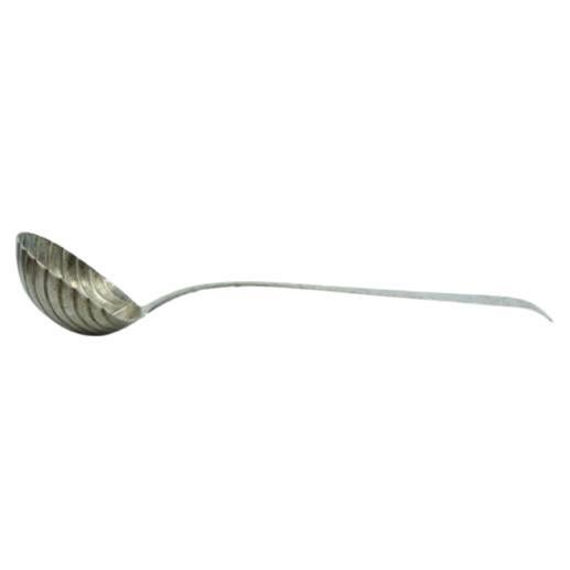 Silver soup ladle in the shape of a shell and handle to be shipped