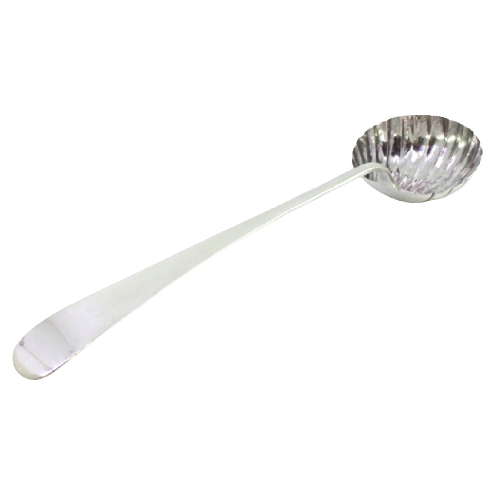 Silver soup ladle in the shape of a shell and smooth handle to be dispatched