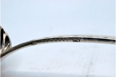 Silver soup ladle in the shape of a shell with engraving on the handle