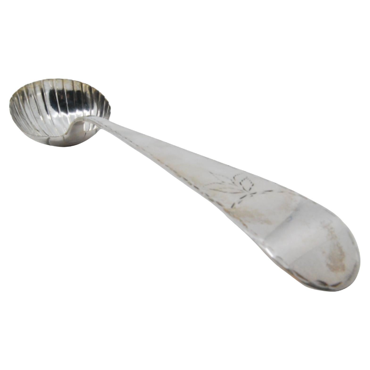 Silver soup ladle in the shape of a shell with engraving on the handle