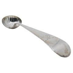 Silver soup ladle in the shape of a shell with engraving on the handle