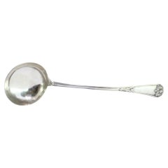 Silver soup ladle w/ frieze
reliefs on the handle surrounding a monogram card