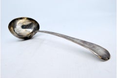 Silver soup ladle with a frieze along the handle to be shipped