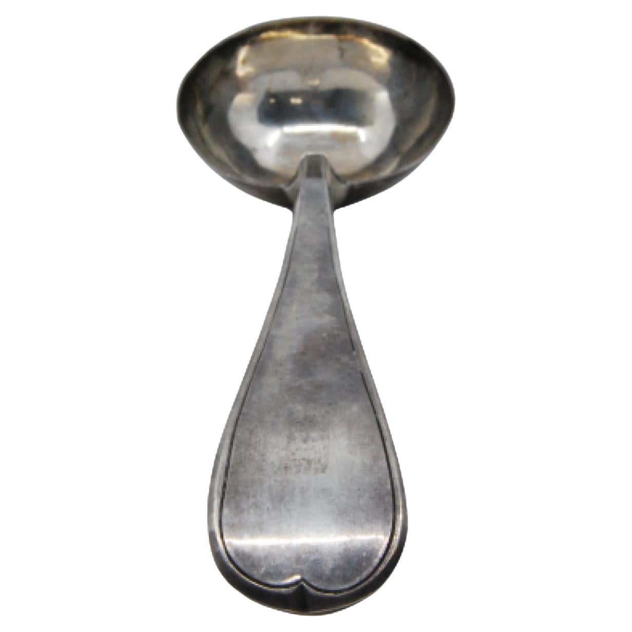 Silver soup ladle with a frieze along the handle to be shipped